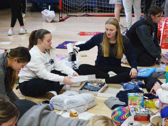 Penn State Abington student athletes wrap gifts for a family in need